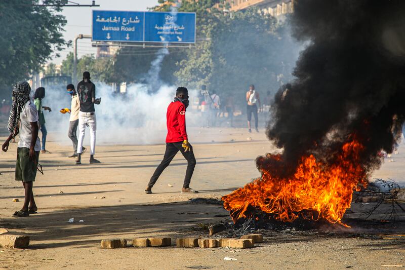 Sudanese protestors clash with security forces during a protest near the presidential palace in Khartoum. EPA