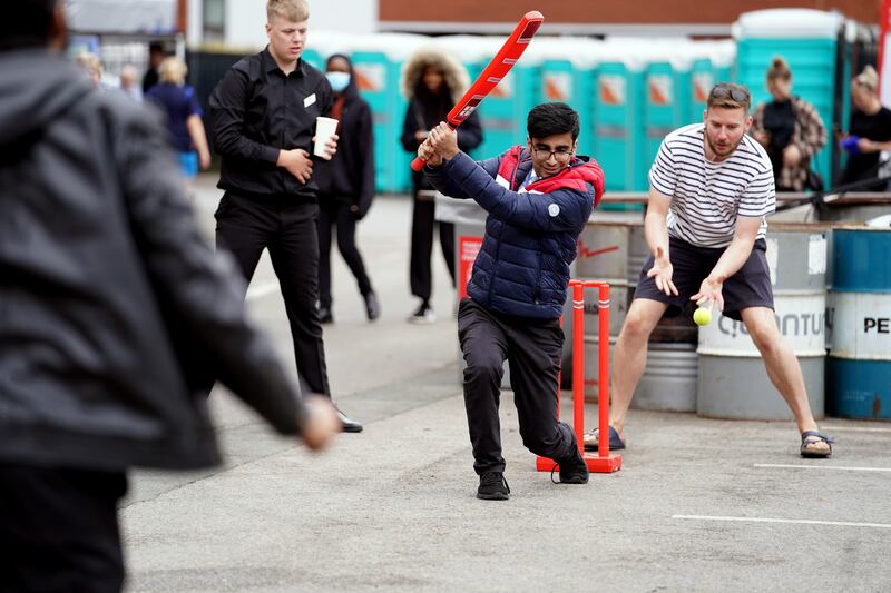 Fans play cricket outside the Emirates Old Trafford venue in Manchester after the fifth Test against England was cancelled over Covid-19 concerns. PA