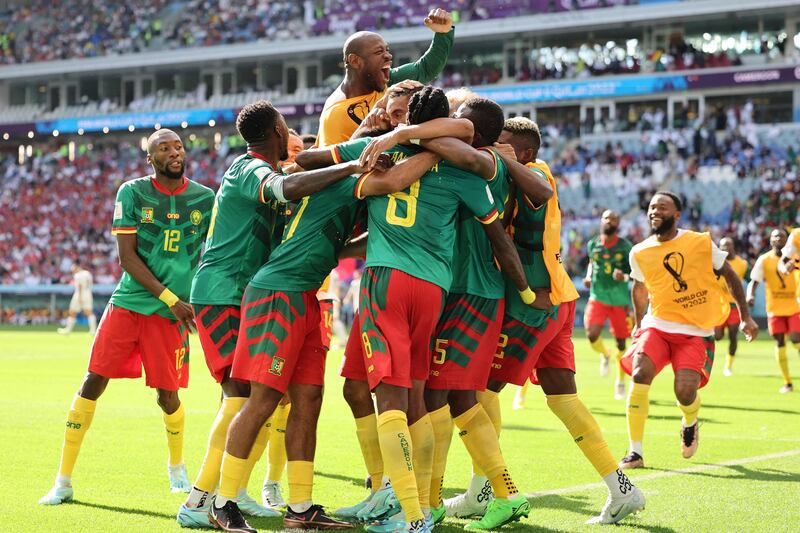 Cameroon players celebrate their first goal against Serbia. AFP