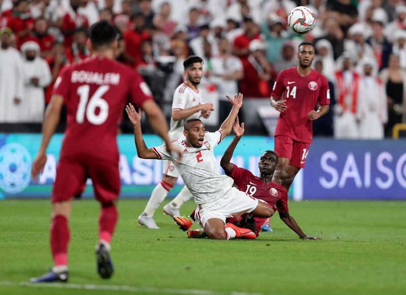 Abu Dhabi, United Arab Emirates - January 29, 2019: UAE's Ali Salmin battles with Qatar's Almoez Ali during the semi final between the UAE and Qatar in the Asian Cup 2019. Tuesday, January 29th, 2019 at Mohamed Bin Zayed Stadium Stadium, Abu Dhabi. Chris Whiteoak/The National