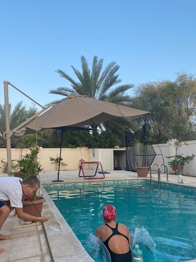 Greg Andrews, Chloe’s father, recording the time as she swims for 14 hours. Courtesy - The Andrews family