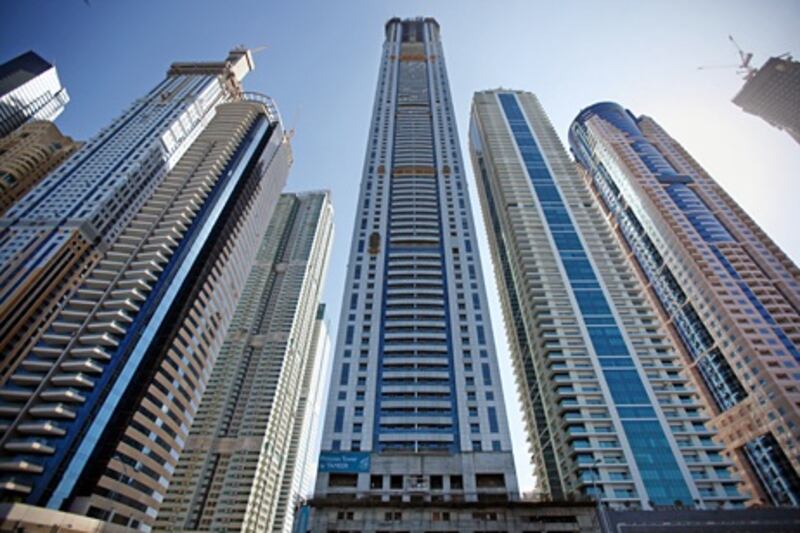 United Arab Emirates - Dubai - January 3, 2011.

BUSINESS: Construction crews work on skyscrapers dotting the north end of the Dubai Marina on Monday, January 3, 2011. At center is the Tameer Holding Investments company's "Princess Tower." Amy Leang/The National