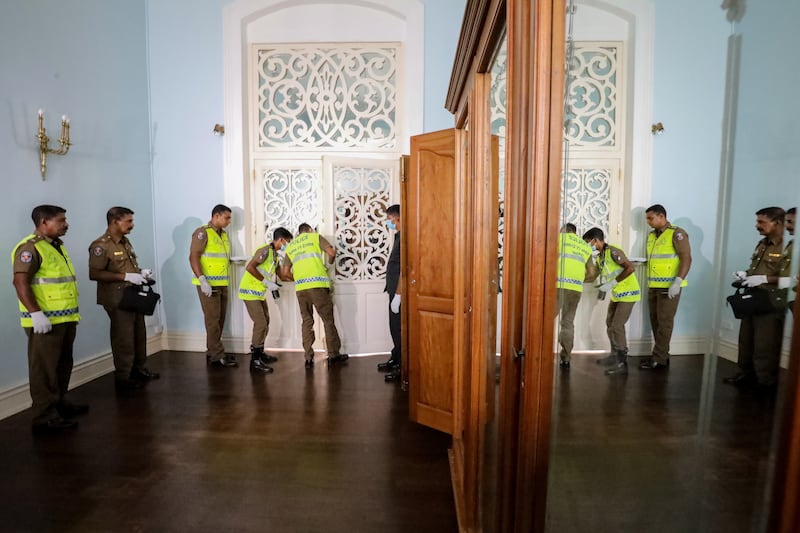 Crime investigation officers at the palace after protesters on July 14 left the premises, ending a five-day occupation of several official buildings. The parliament of Sri Lanka on July 15 accepted the resignation of Gotabaya Rajapaksa, who fled to Singapore after months of anti-government protests. Prime Minister Ranil Wickremesinghe was sworn in as interim president on July 15. EPA