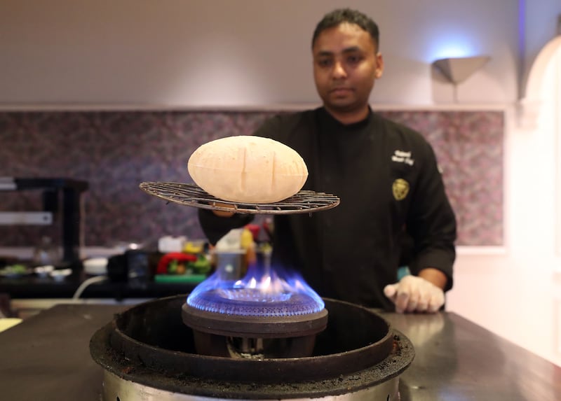 Head chef Vikash Sah cooks the fluffy bread that accompanies the kebab
