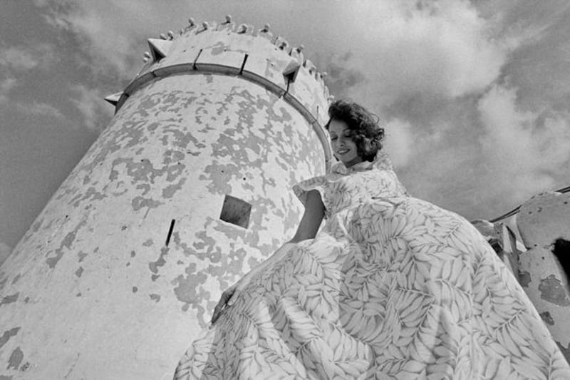 Abu Dhabi, UAE 1974. History Project 3 / 2012. Fashion shoot featuring a model named Kathy wearing clothes by the French Label Cacharel. Shot by French photographer Jack Burlot on location in Abu Dhabi 1974 - featuring The Al Hosn Fort, a dhow, Land Rover and local men. 

Eds Note * Permission needed before use. Karen* 
JACK BURLOT at corporate.images@wanadoo.fr