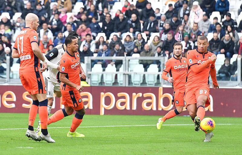 Udinese defenders watch on as Juventus striker Cristiano Ronaldo opens the scoring. EPA