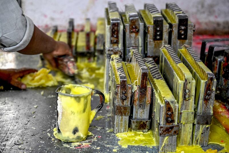 Candles being made at a workshop inside the premises of Blind Relief Association in New Delhi. AFP