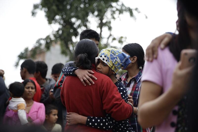 Survivors comfort one another after an earthquake caused serious damage in Kathmandu, Nepal. Narendra Shrestha / EPA