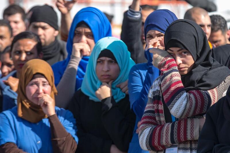 Palestinian colleagues react before the departure of the last Palestinian employees of SodaStream's Rahat factory on February 29. Jack Guez/ AFP

