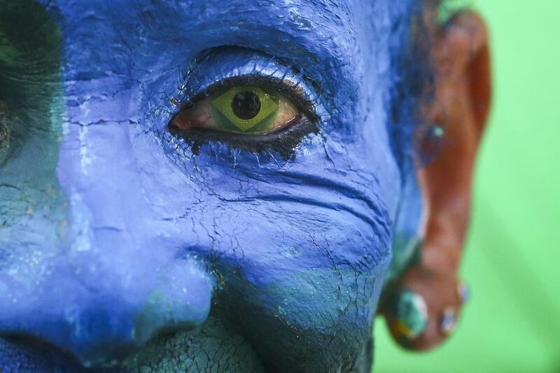 Brazilian fan Ana Luiza dos Anjos wearing contact lenses with the Brazilian national flag and her face painted blue before the Fifa World Cup 2014 group A preliminary round match between Brazil and Mexico at the Fifa Fan Fest in Sao Paulo, Brazil. Diego Azubel / EPA