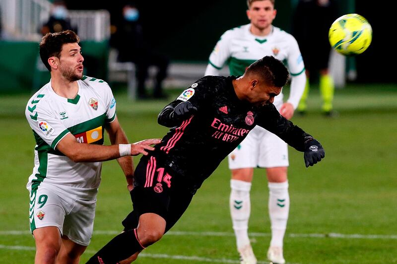 Elche's Lucas Boye challenges Real Madrid's Casemiro. AFP