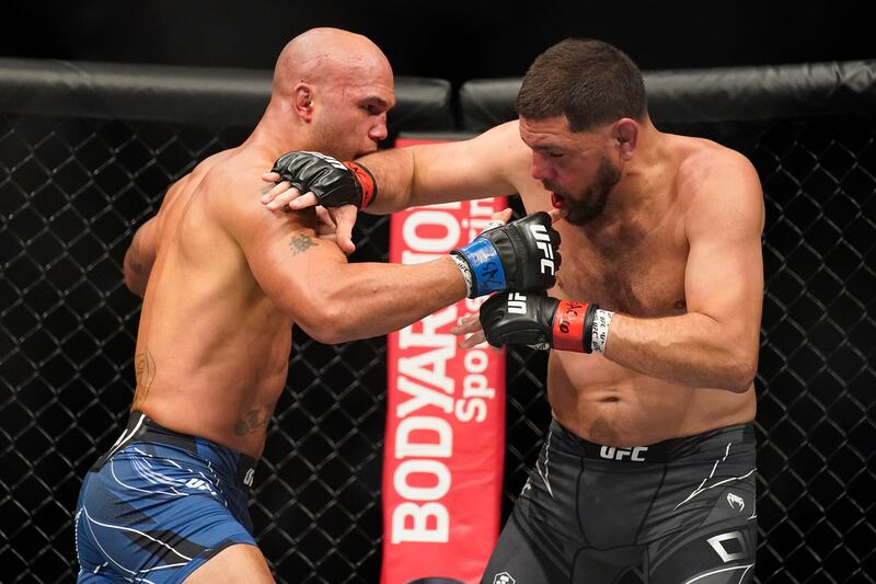 Robbie Lawler, left, throws a punch against Nick Diaz during a middleweight mixed martial arts bout at UFC 266. AP Photo
