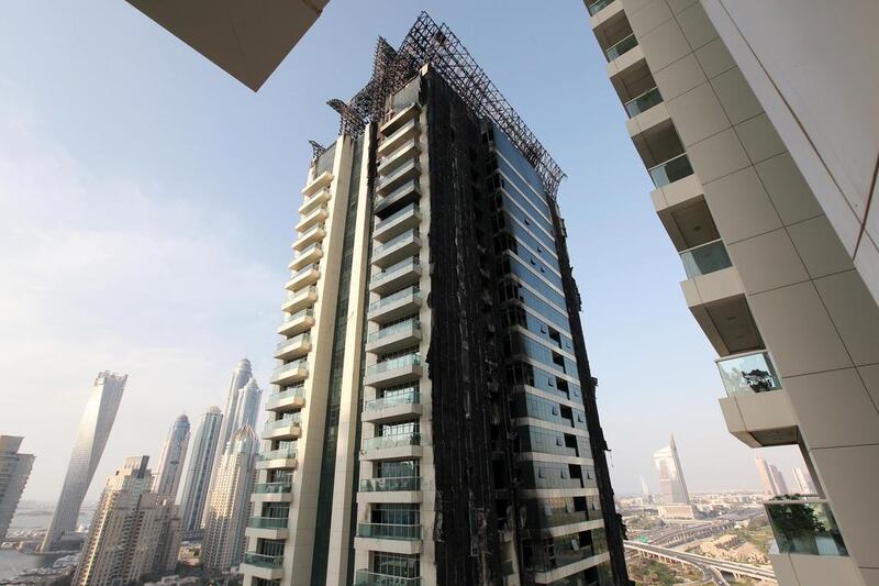 Tamweel Tower in Dubai’s Jumeirah Lakes Towers was badly damaged in November 2012 by a fire that was started by a discarded cigarette. The owners of apartments are still waiting for repairs to begin. Pawan Singh / The National 