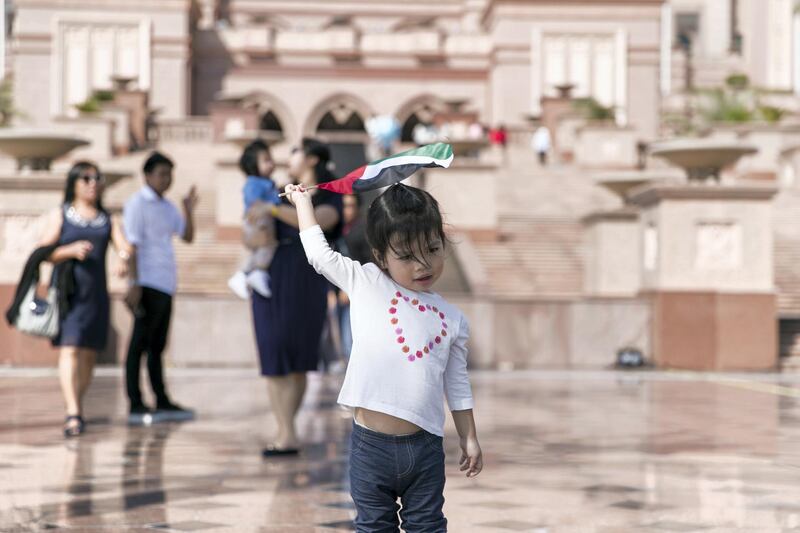 ABU DHABI, UNITED ARAB EMIRATES - NOV 30:

A little girl holds a UAE flag by Emirates Palace.

(Photo by Reem Mohammed/The National)

Reporter:  
Section: NA