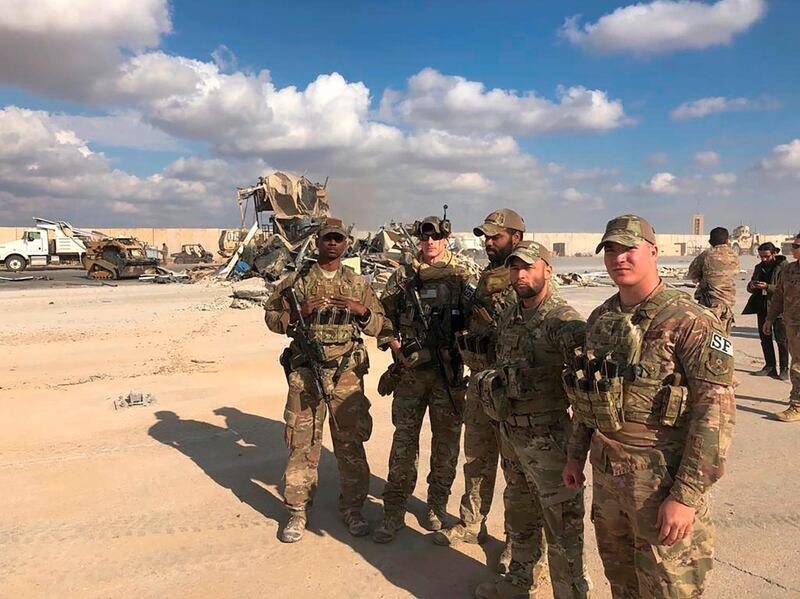 FILE - In this Jan. 13, 2020 file photo, U.S. Soldiers stand at a site of Iranian bombing at Ain al-Asad air base in Anbar, Iraq. On Tuesday, March 23, 2021, Iraqi officials said Iraq has sent a formal request to President Joe Bidenâ€™s administration for a date to resume strategic talks on bilateral relations and the withdrawal of remaining U.S. combat forces. The talks, which began in June under the Trump administration, would be the first under Biden, who assumed office in January. (AP Photo/Qassim Abdul-Zahra, File)