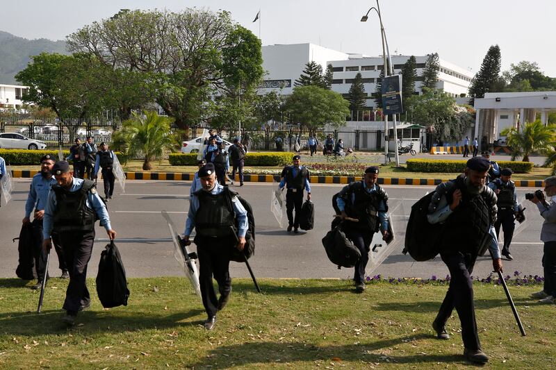 Police officers with anti-riot gear arrive at the National Assembly, in Islamabad, Pakistan, as  Prime Minister Imran Khan faces a tough no-confidence vote on Saturday. AP