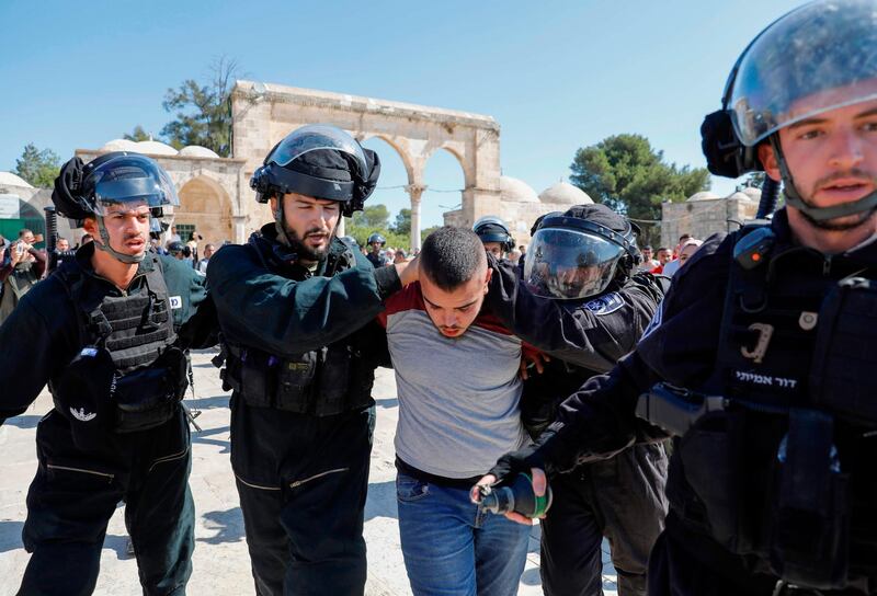 Israeli security forces detain a Palestinian at the Al Aqsa Mosque. AFP