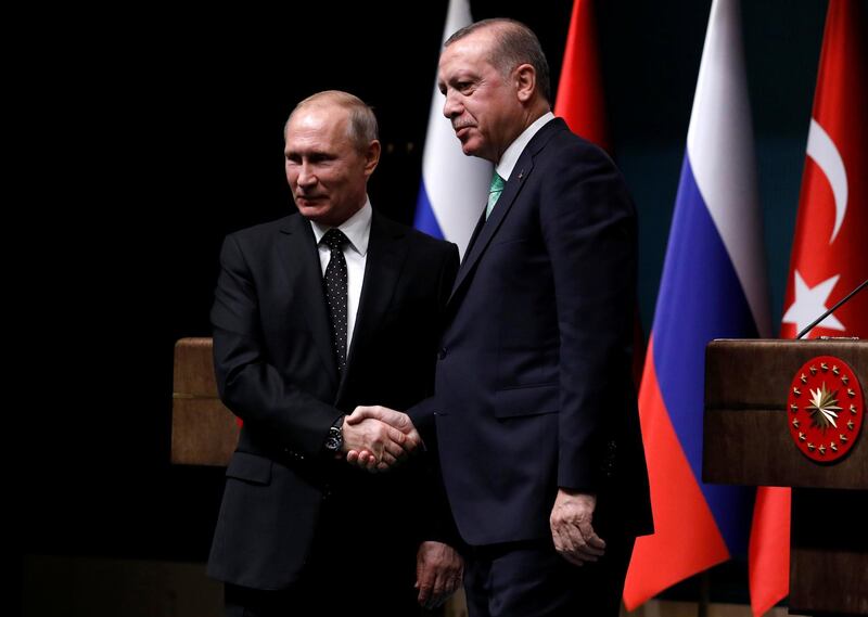Turkish President Tayyip Erdogan shakes hands with Russian President Vladimir Putin after a news conference in Ankara, Turkey, December 11, 2017. REUTERS/Umit Bektas