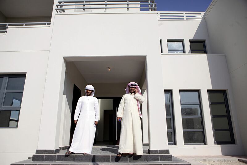 (Abu Dhabi October 30, 2012) Ali Ahmad Al Hajery, right, and his brother Facial tour Ali's new home in the Al Falah neighborhood after picking up the keys to his new house at the Abu Dhabi Municipality  in Abu Dhabi October 30, 2012. (Sammy Dallal / The National)
