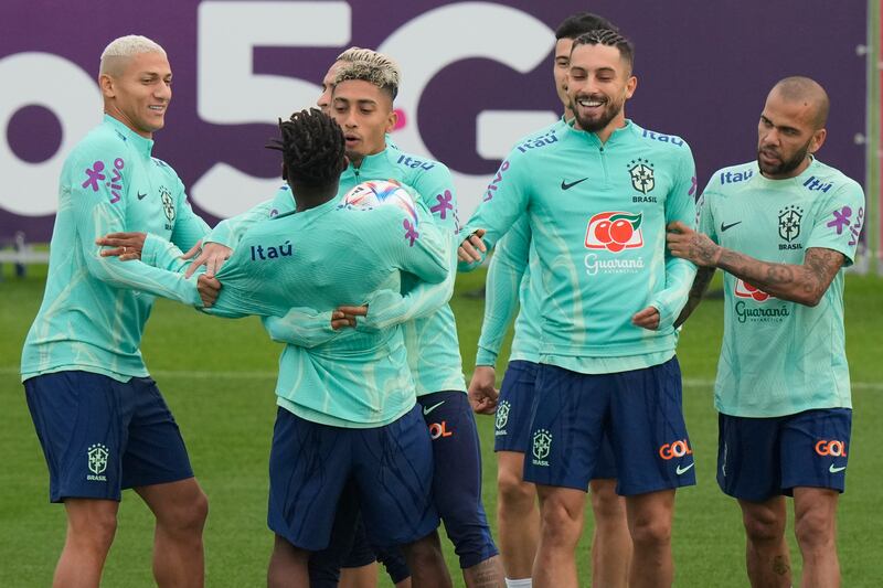 Brazil players joke with teammate Fred. AP