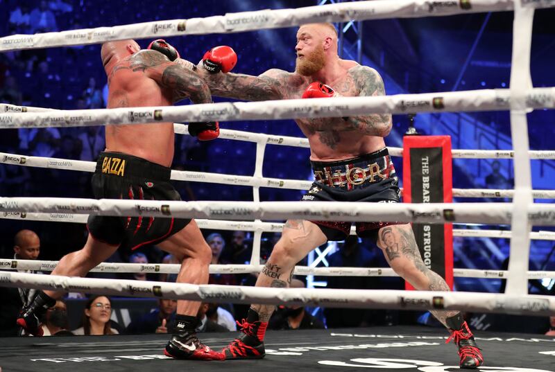 Thor Björnsson, right, lands a jab on Eddie Hall.