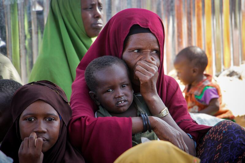Somalis who fled drought-stricken areas sit at a makeshift camp on the outskirts of the capital Mogadishu. AP