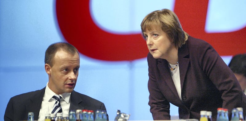 LEIPZIG, GERMANY - DECEMBER 2:  Friedrich Merz (L), head of the Christian Democratic Union (CDU) faction in the Bundestag and Angela Merkel, head of the party, speak prior to Merz's speech on tax reform at the CDU party congress December 2, 2003 in Leipzig, Germany. The CDU, Germany's main opposition party, is proposing a string of counter reforms in response to the social and economic reform plans of the current Social Democrat/Green government. (Photo Sean Gallup/Getty Images)  