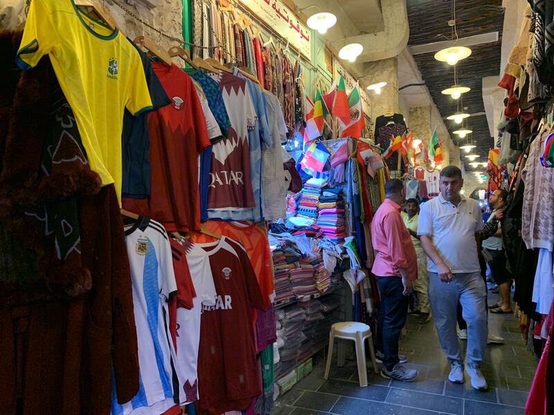 An array of football shirts from teams represented at the tournament are on sale. 

