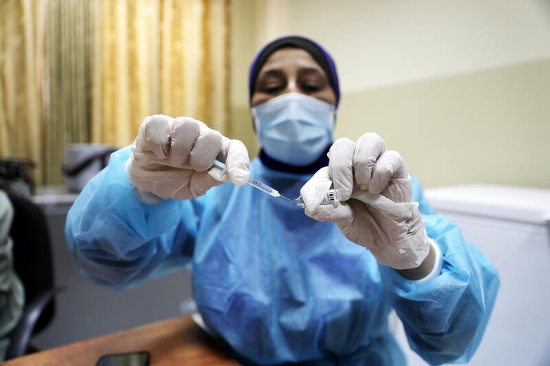 epa09259618 A Palestinian medical worker prepares a dose of Pfizer-BioNTecha vaccine against covid19 at the Palestinian Medical center in the West Bank city of Dura, 10 June 2021. According to Palestinian Health Minister Mai Alkaila 404,142 people were vaccinated in the West Bank and the Gaza Strip.  EPA/ABED AL HASHLAMOUN