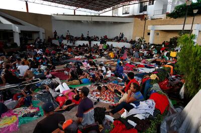 People rest as a thousands-strong caravan of Central American migrants heading for the U.S. sets up camp for the night in Pijijiapan, Mexico, Thursday, Oct. 25, 2018. Many migrants said they felt safer traveling and sleeping with several thousand strangers in unknown towns than hiring a smuggler or trying to make the trip alone.(AP Photo/Rebecca Blackwell)