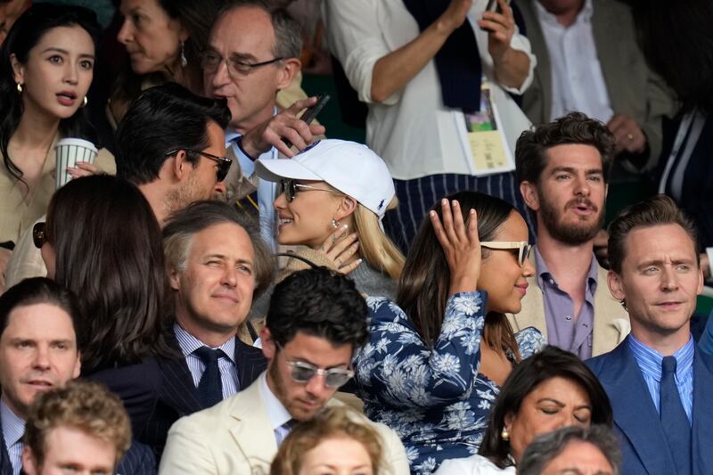Actor Andrew Garfield, top right, singer Ariana Grande, centre, and actor Tom Hiddleston, bottom right, sit in the stands. AP 