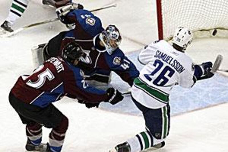 Mikael Samuelsson of the Canucks, No 26, scores a hat-trick against the Avalanche.