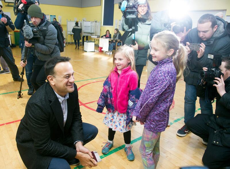 Irish Taoiseach Leo Varadkar (L) chats with two little girls after voting at a polling station during general elections in Dublin, Ireland.  EPA