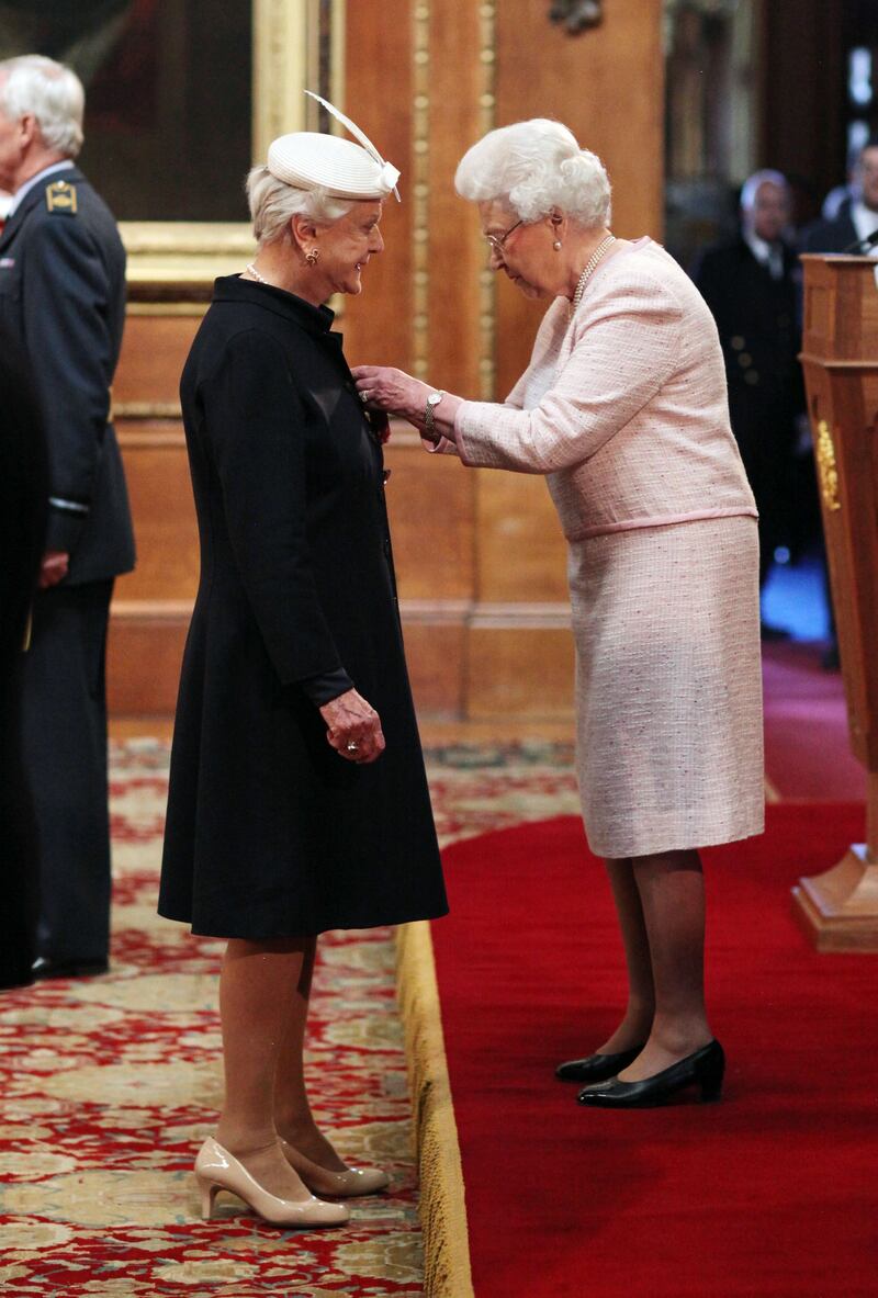 Angela Lansbury is made a Dame Commander by Queen Elizabeth II during a ceremony at Windsor Castle. PA