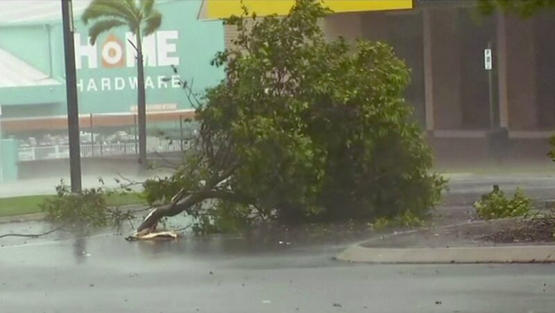 In this image captured from video, tree debris lies on the street as wind gusts in Bowen, eastern Australia. Cyclone Debbie lashed islands, damaged roofs and cut power on Tuesday as it edged toward Australia’s tropical northeast coast. Australian Broadcasting Corporation via AP
