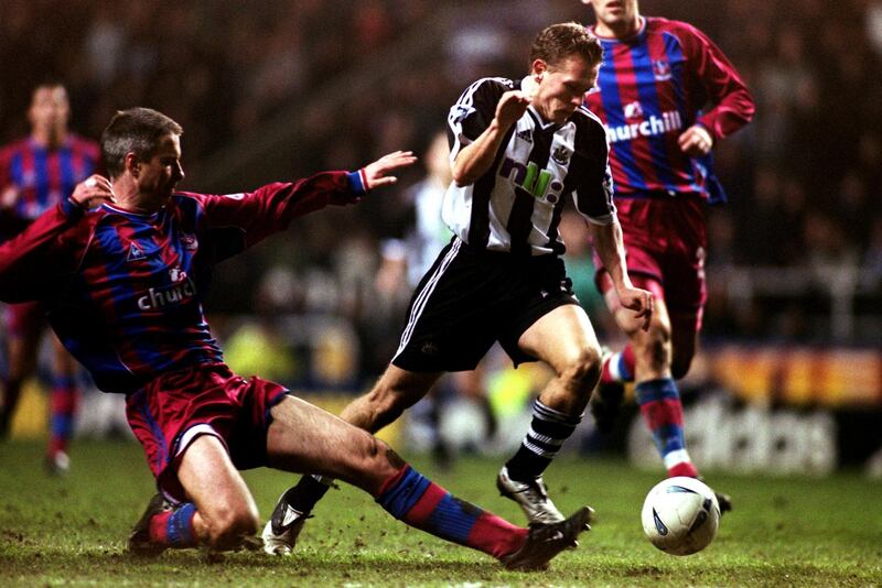 Newcastle's Craig Bellamy runs the ball past Crystal Palace's Kit Symons  (Photo by Steve Morton/EMPICS via Getty Images)