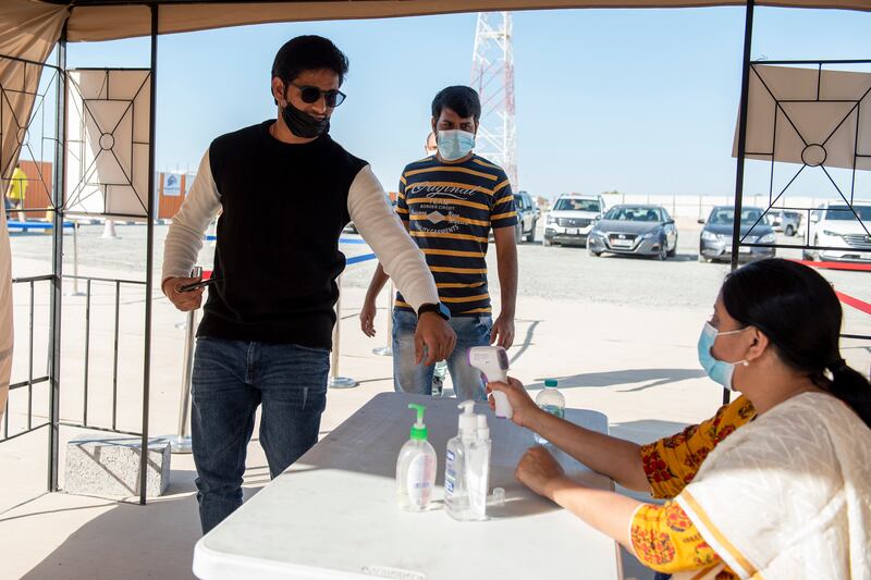 People have their temperatures checked before entering the construction site of the UAE’s first traditional Hindu temple, in Abu Dhabi. All Photos by Vidhyaa Chandramohan for The National