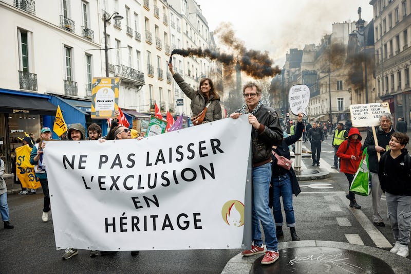Activists hold a banner that translates to: 'Do not leave exclusion as a legacy', during a protest to raise awareness of the social impact of the Olympics in Paris. AP