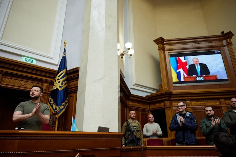 President Volodymyr Zelenskiy claps as British Prime Minister Boris Johnson addresses the Ukrainian Parliament in Kyiv via videolink. Reuters