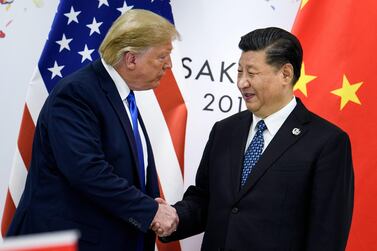 Mr Trump, left, with Chinese president Xi Jinping. The trade war between the world's two largest economies dampened economic growth this year. AFP