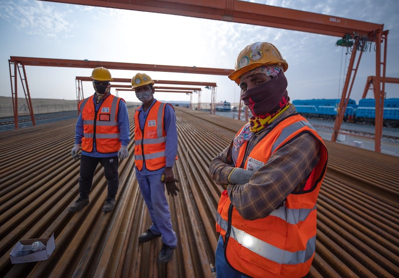 Railroad workers preparing tracks at the depot. Victor Besa / The National