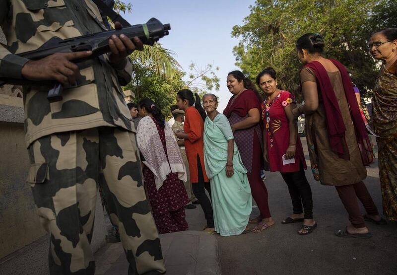 Indian women line up at the same polling station before BJP leader Narendra Modi arrived to vote on April 30, 2014 in Ahmedabad, India. Kevin Frayer / Getty Images