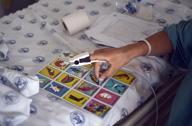 Edith Aguilar Valdez a Covid-19 patient plays games while waiting to be discharged, in the Juarez de Mexico Hospital, in Mexico City. AFP