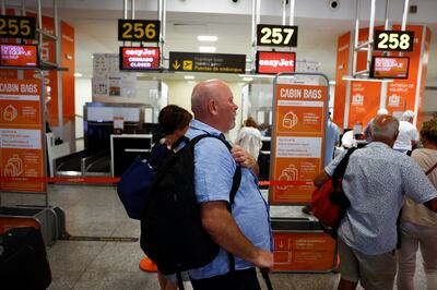 Easyjet passengers queue at check-in desks at Malaga-Costa del Sol Airport. Reuters