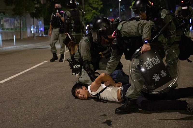 Police detain a protester during a rally marking the third month anniversary of alleged triads members attacking protesters and residents in Yuen Long, New Territories, Hong Kong, China. EPA