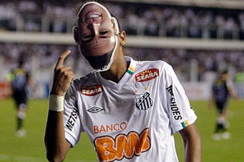 Brazil's Santos Neymar wears a mask depicting himself in celebration after scoring the third goal of his team against Chile's Colo Colo in Santos, Brazil. Andre Penner / AP Photo