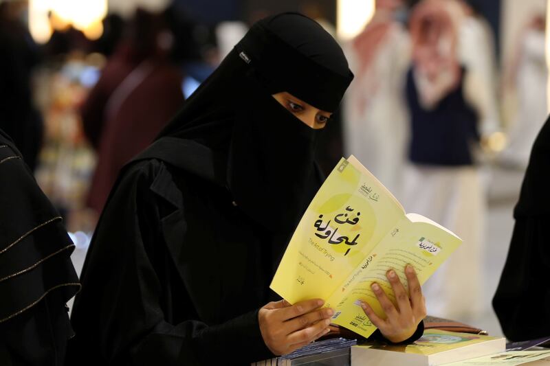 A Saudi woman reads during the Riyadh International Book Fair.