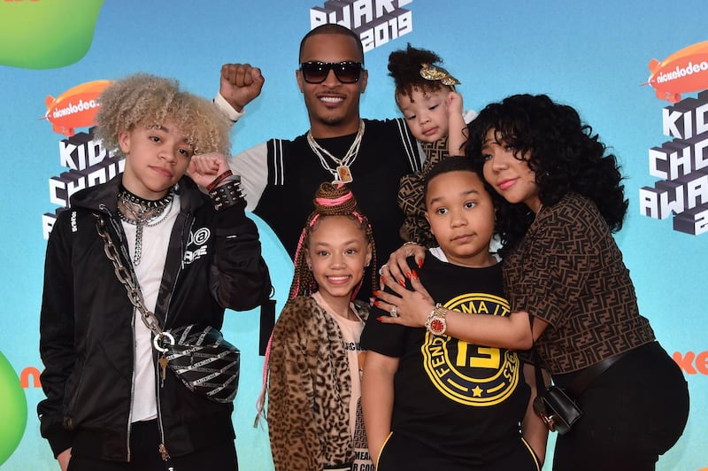 US rapper T.I., centre, wife singer-songwriter Tiny, right, and their children arrive. AFP