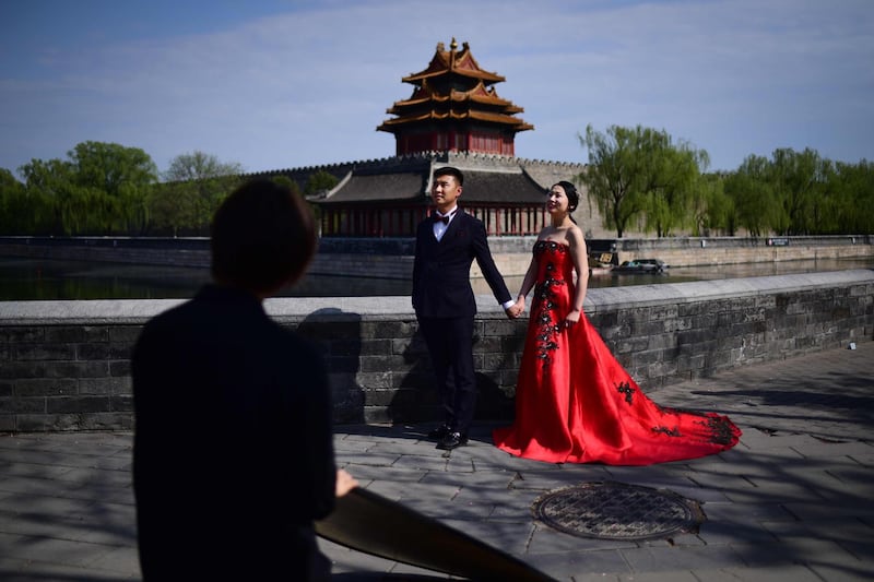 A couple poses for wedding photos near the Forbidden City in Beijing.  Wang Zhao / AFP Photo
