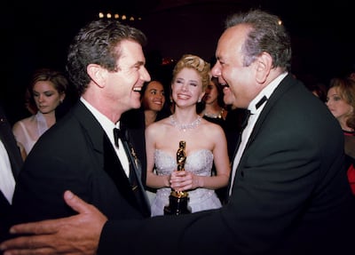 Oscar-winning director Mel Gibson (L) shares a laugh with actor Paul Sorvino (R) as daughter Mira Sorvino enjoys the moment at the Governor's Ball at the 68th Academy Awards, March 25 in Los Angeles. Mira Sorvino (C) holds the Oscar she won as Best Supporting Actress for her role in "Mighty Aphrodite